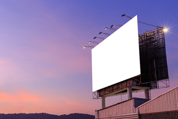 Large white advertising billboard on top of the building and sky background