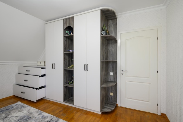 Large white cabinet in living room with wooden floor