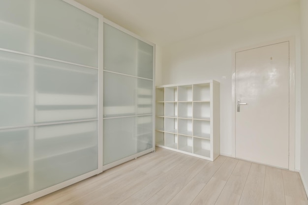 A large white glazed wardrobe in a bright dressing room of a cozy home