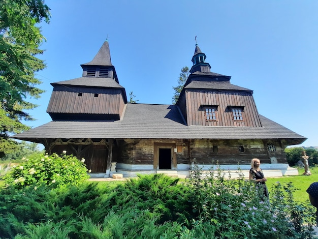 A large wooden building with a bell tower on the front.