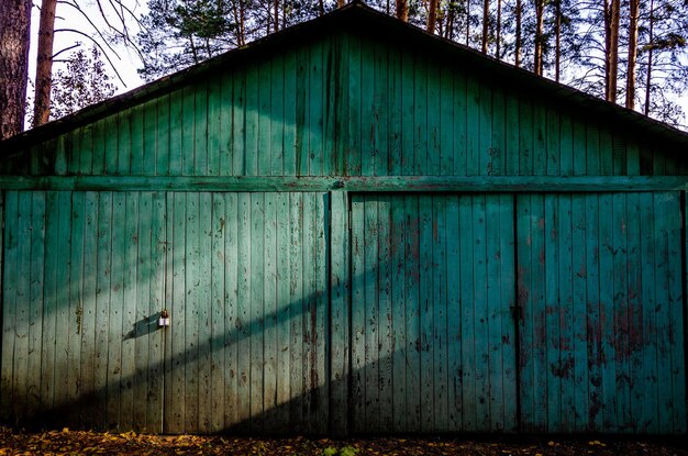 A large wooden shed illuminated by the sun.