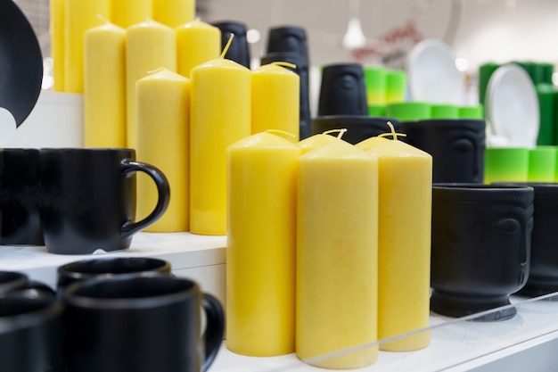 Large yellow candles in a gift shop. Close-up.