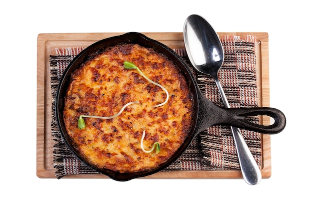 Lasagna in a cast iron pan The view from the top On white background