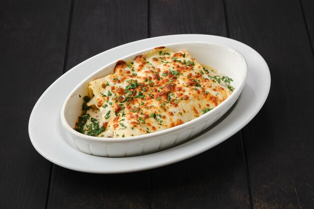 Lasagna with cheese, chicken and vegetables on a plate