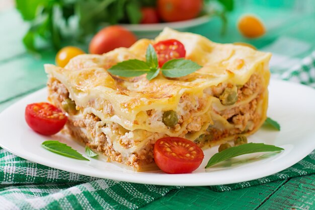 Lasagna with minced meat, green peas and sauce