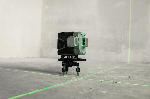 Laser level, construction, finishing work in the room. Laser building level with green beams