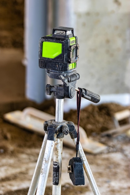 Laser level on a tripod at a construction site Closeup Taking measurements with a laser