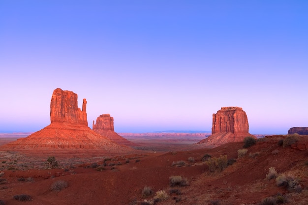 The last rays of the setting sun illuminate famous Buttes of Monument Valley on the border between Arizona and Utah, USA