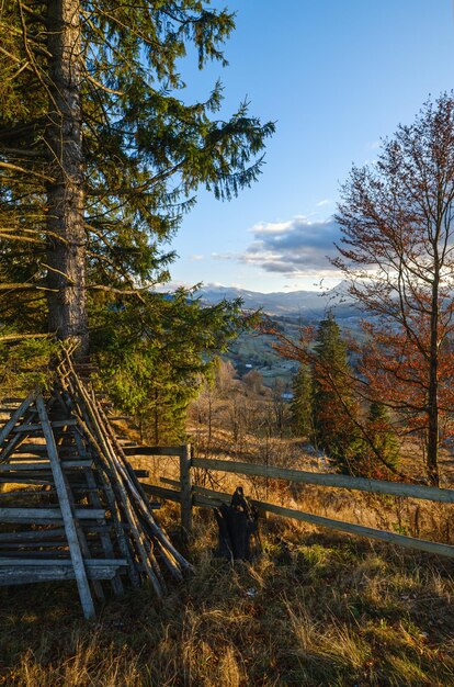 Late autumn mountain pre sunset scene with snow covered tops in far Picturesque traveling seasonal nature and countryside beauty concept scene Carpathians Ukraine