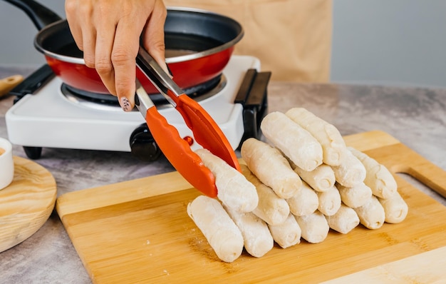 Latin american cook preparing and frying venezuelan tequenos latin appetizer