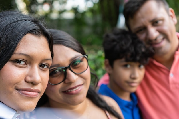 Latin family taking a selfie at park