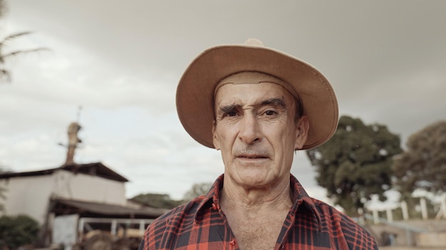 Latin farmer man in the casual shirt in the farm on the farm background