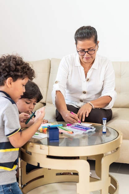 Latin grandmother spending time together with her grandchildren at home