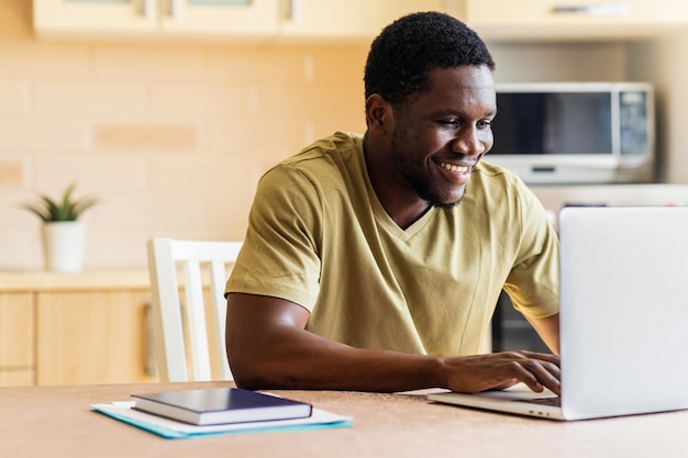 Latin hispanic man freelancer using laptop studying online working from home