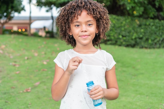 Latin Little girl playing with bubbles