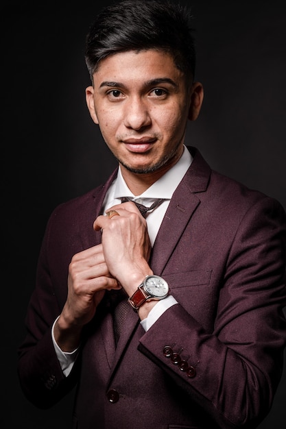 Latin man in suit on black background, portrait