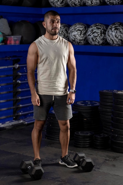 Latin man wearing sportswear standing at the gym ready to exercise