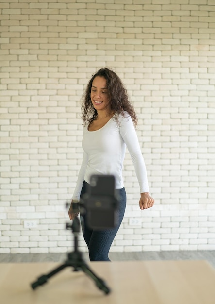 Latin woman created her dancing video by smartphone camera To share video to social media application