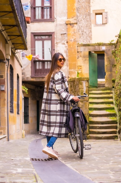 Latin woman doing bicycle tourism in the city Ecological tourism lifestyle