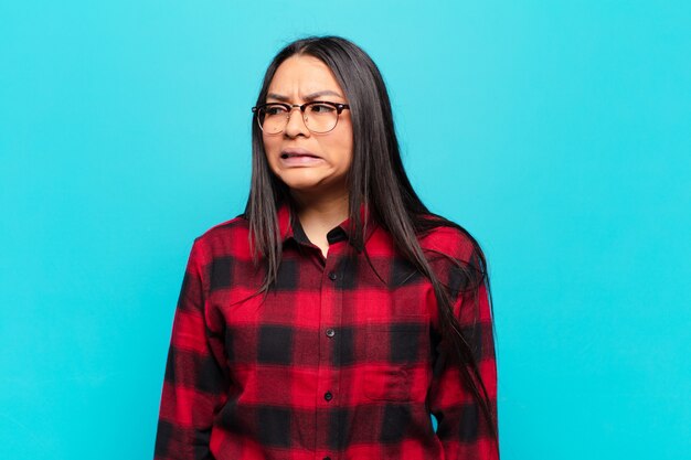 Latin woman looking worried, stressed, anxious and scared, panicking and clenching teeth