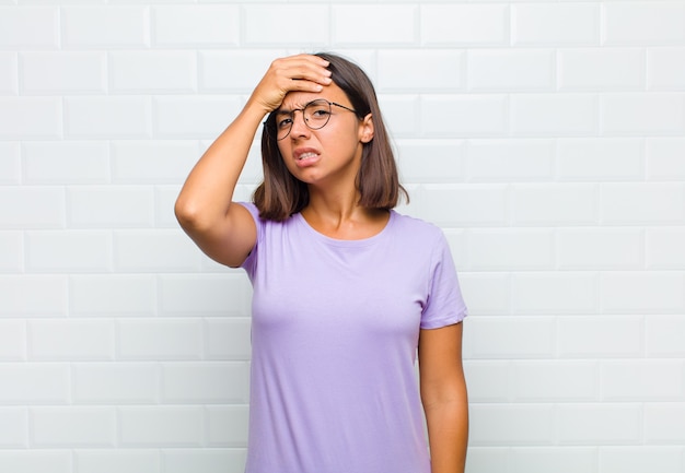 Latin woman panicking over a forgotten deadline, feeling stressed, having to cover up a mess or mistake