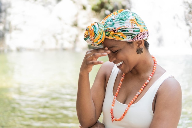 Latin woman poses confidently wearing colorful headscarf