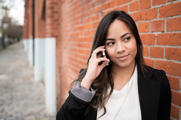 Latin woman talking on the phone.