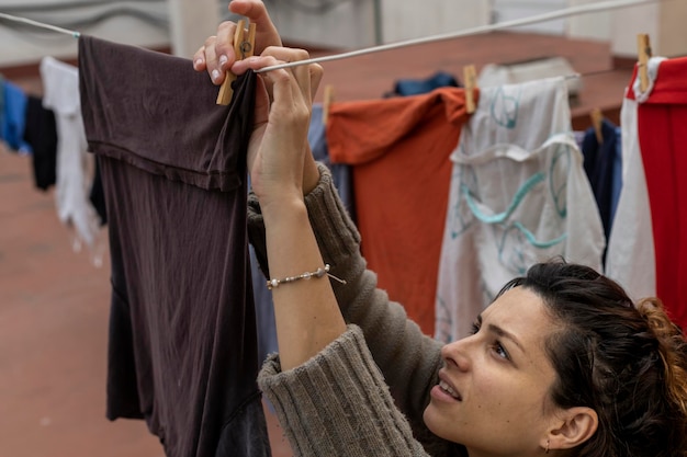 Latina woman hanging clothes on clothesline