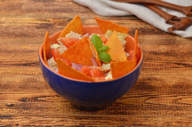 Latino appetizer of vegetables sauce and chips on a wooden background