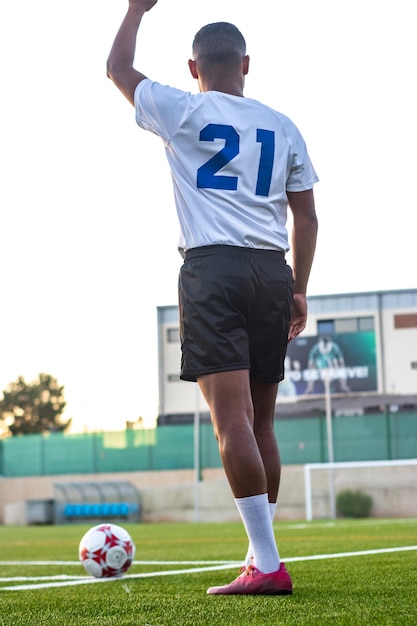 Latino soccer player marking the strategy before taking a corner in a soccer field