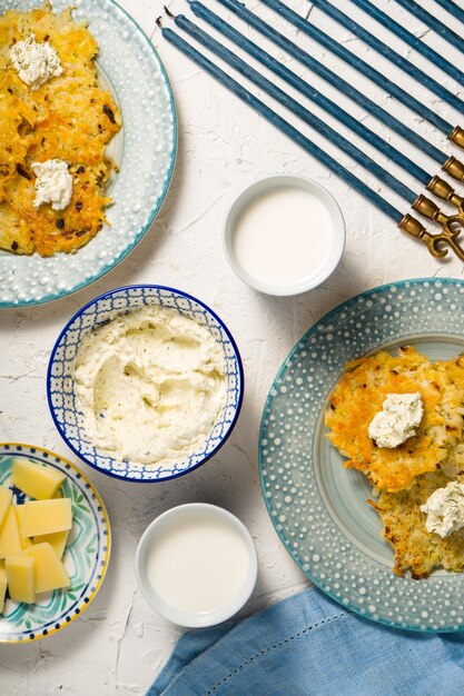 Latkes milk and cheese cheese Hanukkah on a white table