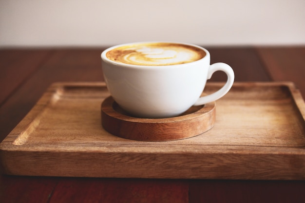 Latte art coffee on wooden table on coffee time