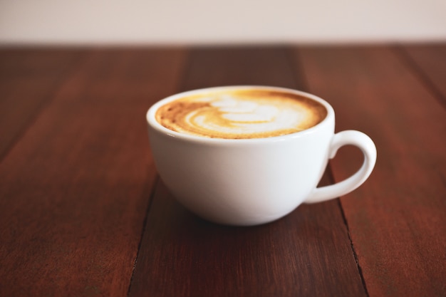 Latte art coffee on wooden table on coffee time