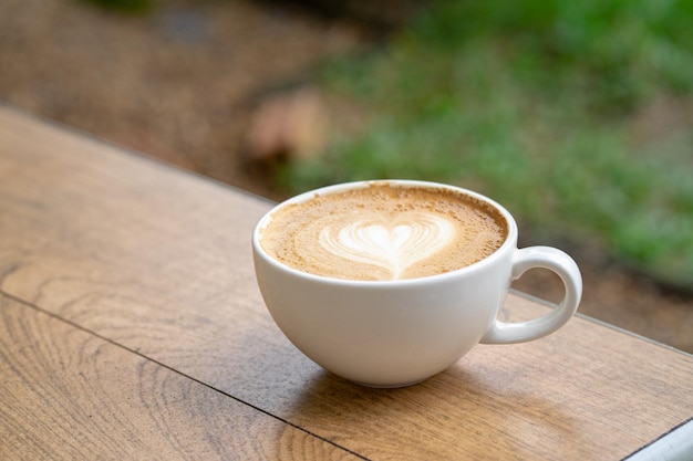 Latte coffee or cappuccino coffee in white cup with latte art