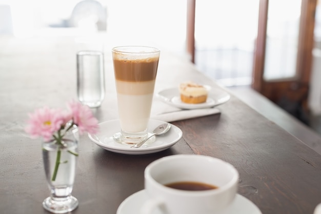 Latte and coffee on table