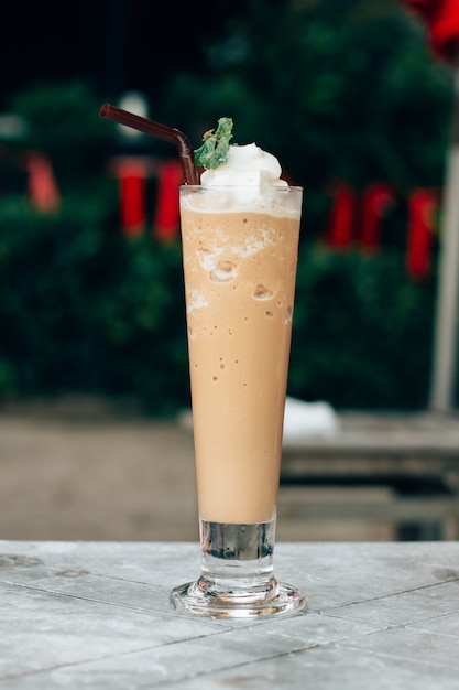 Latte mixed with whipped cream , clipping path. Ice coffee blender in a  glass. 