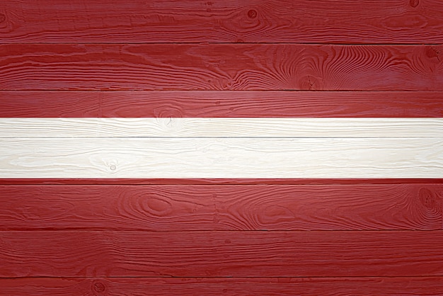 Latvia flag painted on old wood plank background