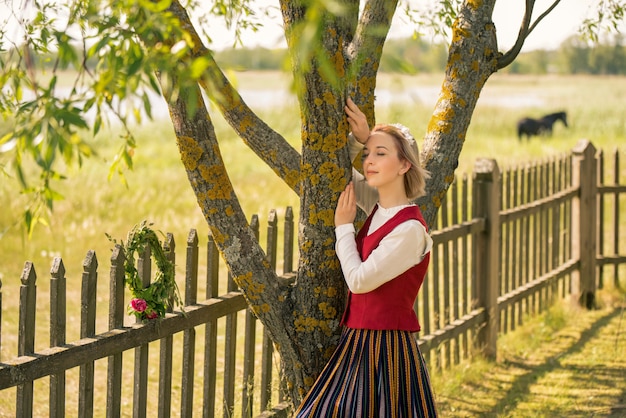 Latvian woman in traditional clothing. Ligo folk.