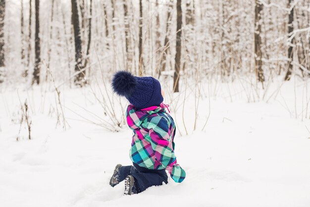 Laughing baby girl playing in the snow