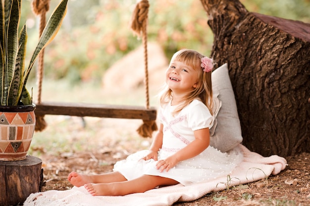 Laughing baby girl wearing princess dress outdoors