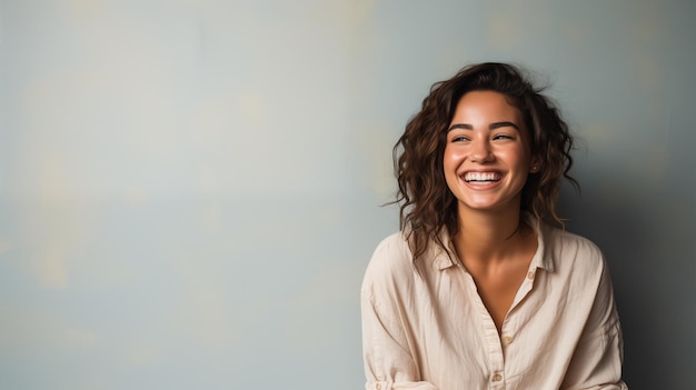 Laughing boho style young female woman or girl with short haircut in jeans shirt on neutral backdrop