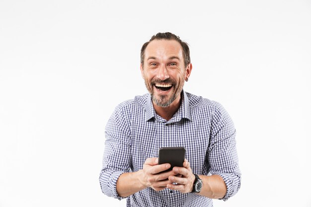 Laughing emotional adult man using mobile phone.