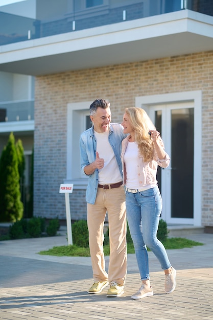 Laughing happy man and woman with keys