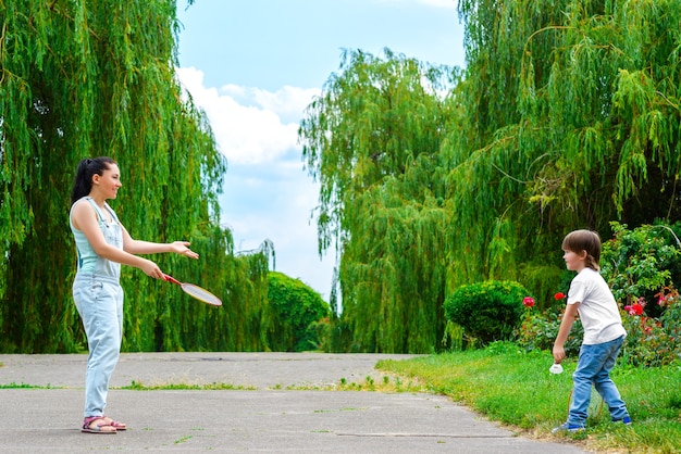 Laughing mum playing with son in park