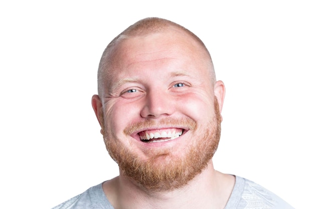 Laughing redhaired man with a beard and beautiful blue eyes Positivity optimism and emotions Isolated on white background Closeup