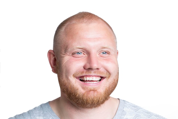 Laughing redhaired man with a beard and beautiful blue eyes Positivity optimism and emotions Isolated on white background Closeup