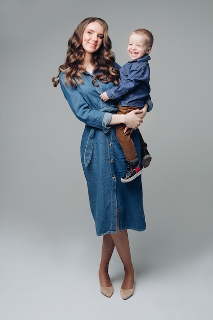 Laughing son and smiling mother in studio