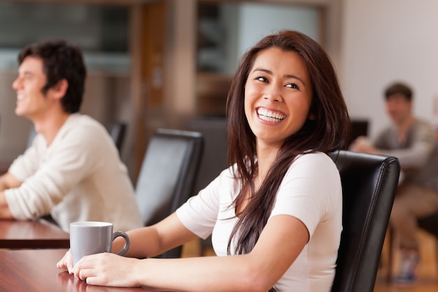 Laughing woman having a tea