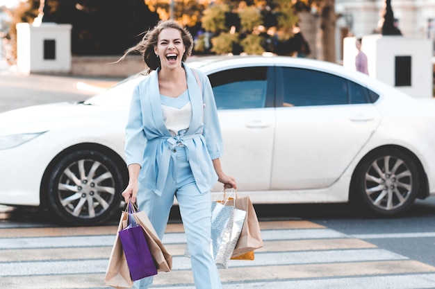 Laughing woman shopping in city