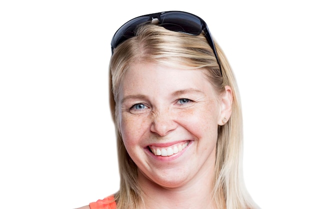 Laughing woman with freckles and sunglasses on her head Emotions optimism and positivity Isolated on white background Closeup